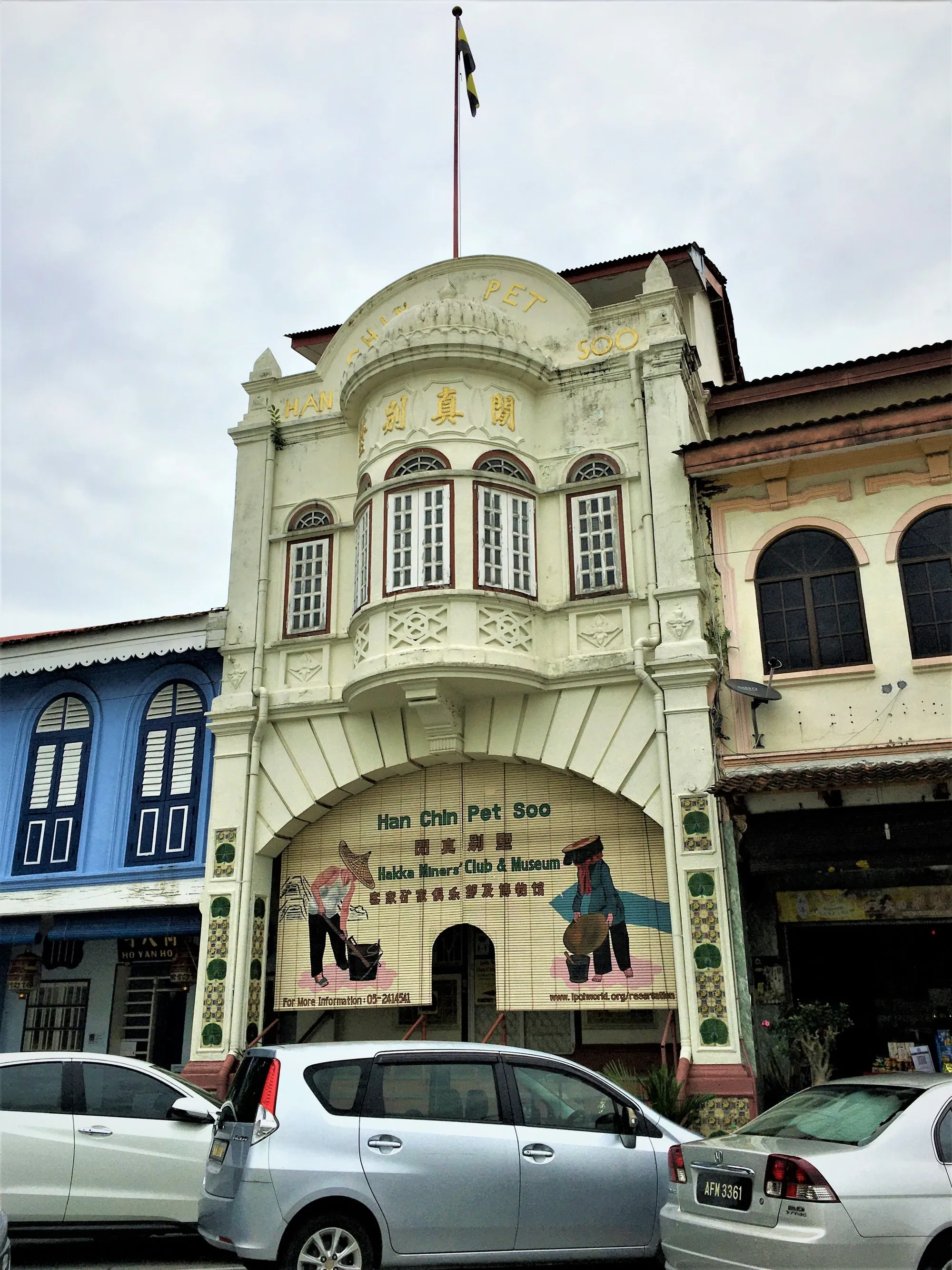 Ornate cream and green facade of the Han Chin Pet Soo building on Jalan Bijeh Timah, Ipoh